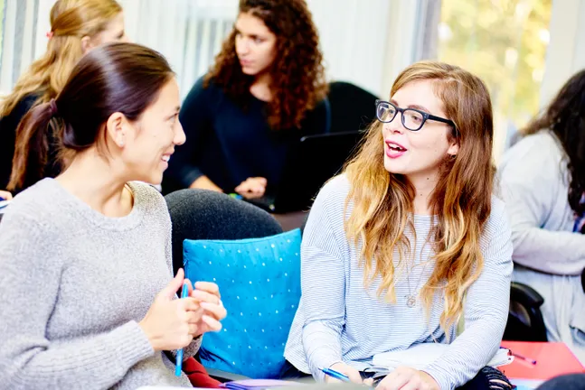 Postgraduate students discussing their work in a Psychology seminar