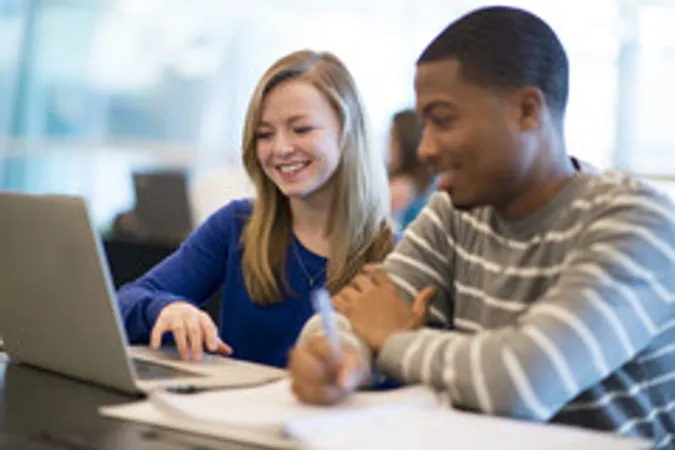 Students working together on laptop